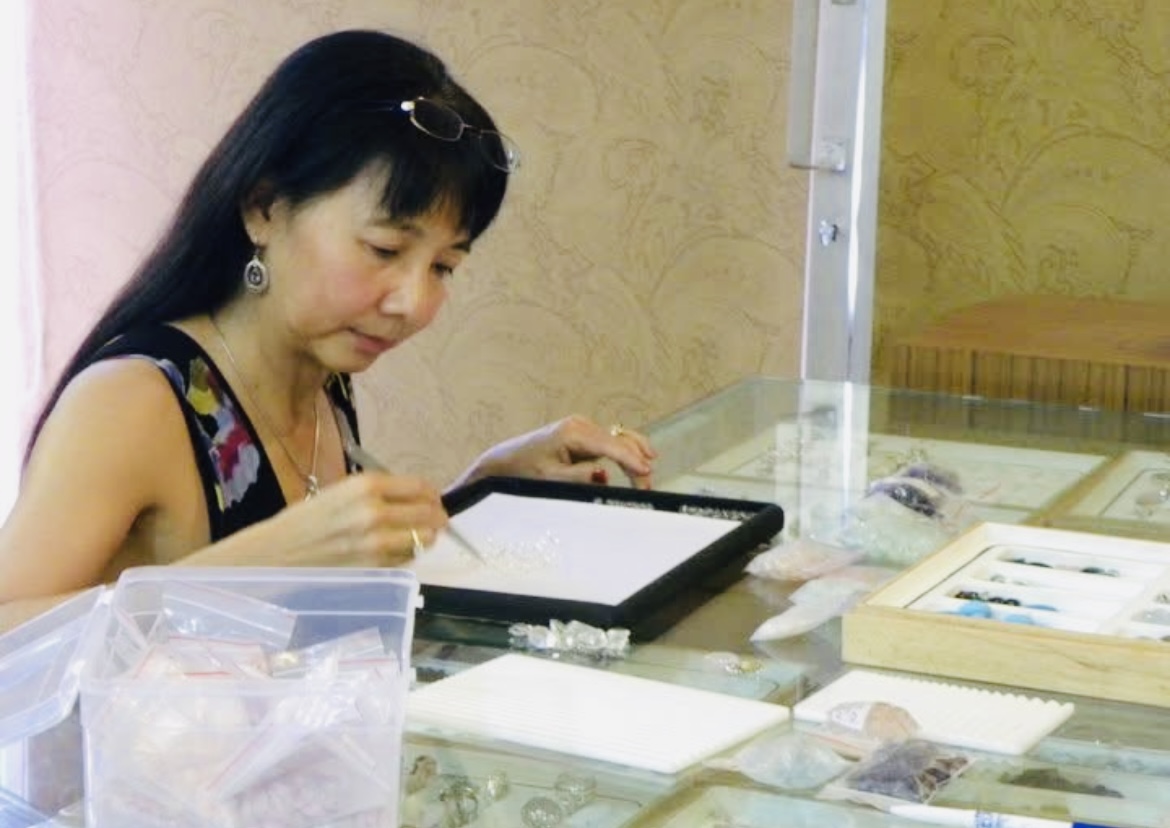 Valued client inspecting loose gemstones at our outlet