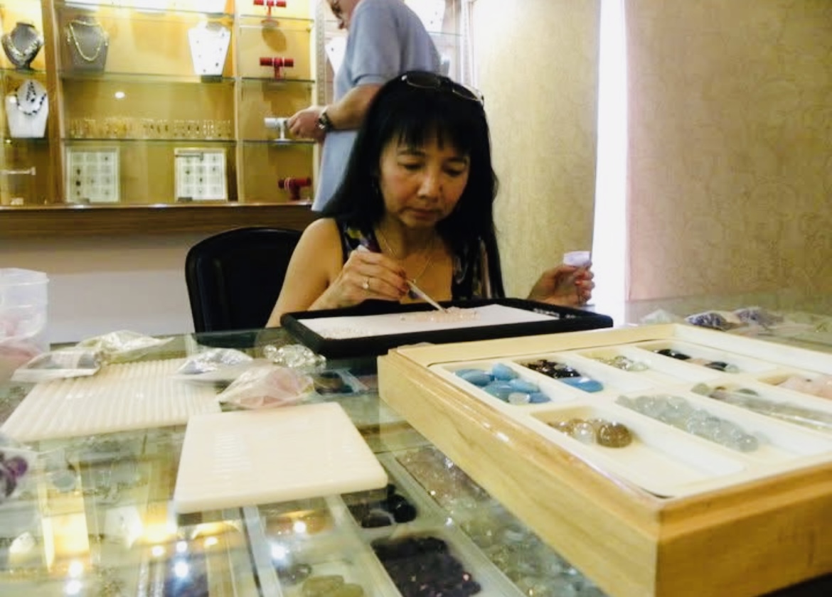 Client reviewing a tray of fine gemstones
